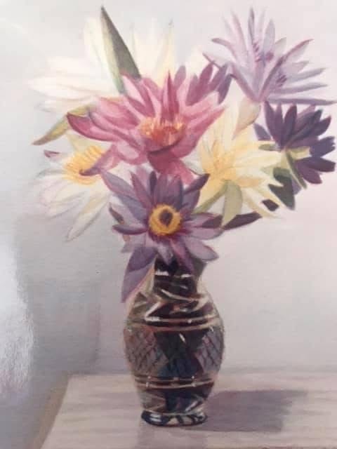 Watercolor of pink, white, and purple dahlias arranged in a cut crystal vase on a wooden surface