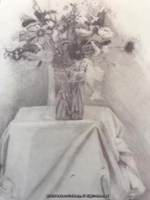 Graphite drawing of a mixed floral bouquet in a glass vase on a draped table, signed Barbara Steinberg 2019