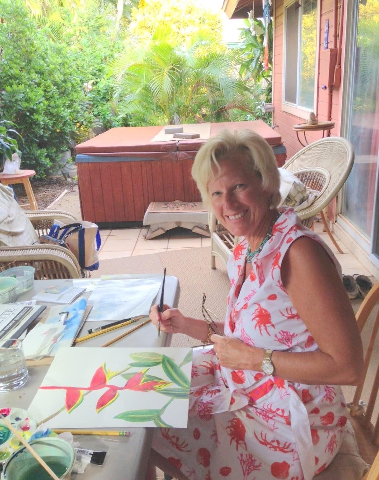 Adult student painting a heliconia watercolor on the lanai during a private class with Barbara Steinberg
