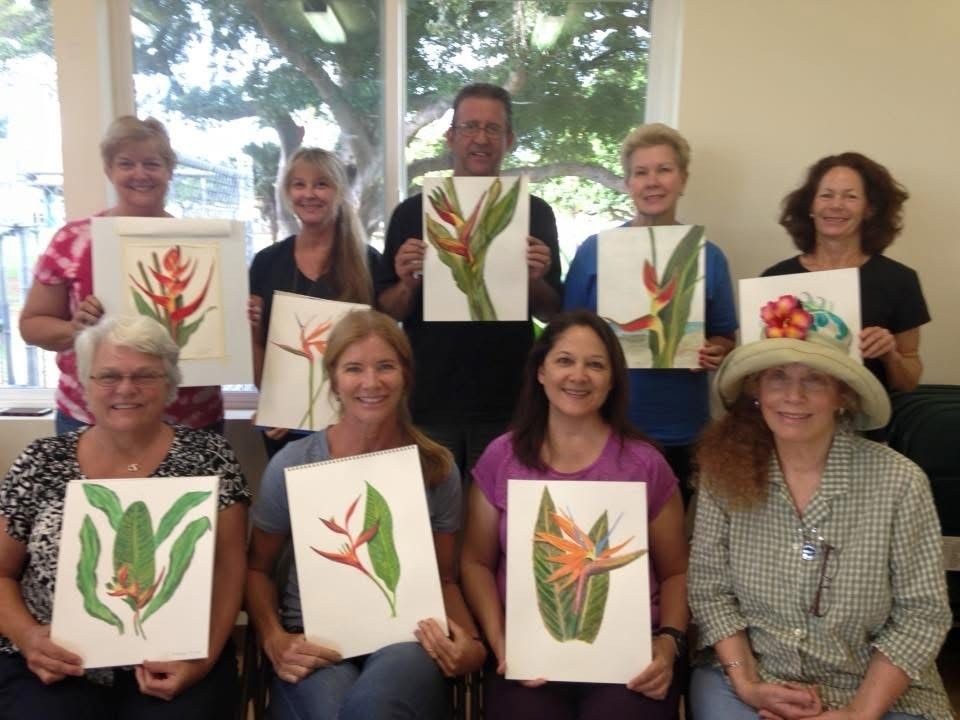 Large group of adult students holding their tropical bird of paradise watercolor paintings